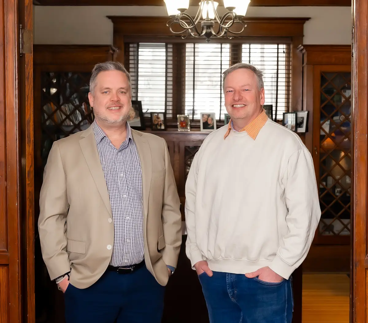 Morgan and Adam standing in office. Natural wood trim - character.